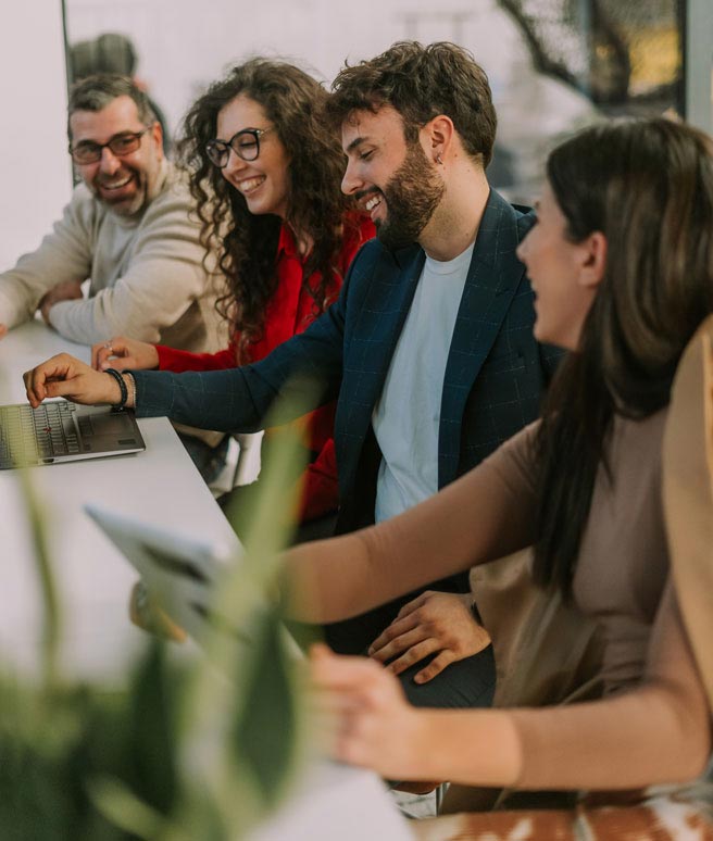 Group of coworkers gathered at their desk